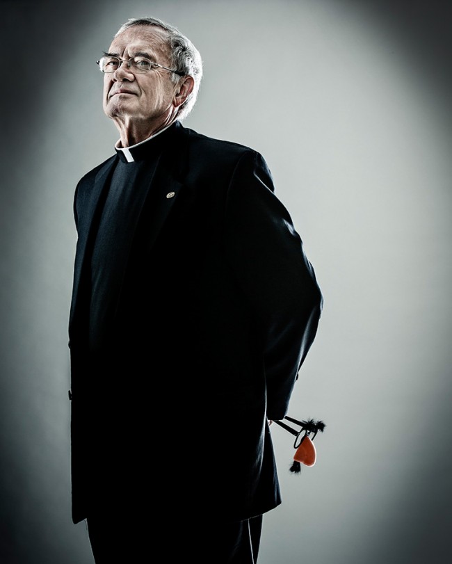 Father John Malone, vice president for mission, poses for a portrait December 3, 2013. Malone holds a pair of "groucho glasses," representative of his sly sense of humor. Taken for St. Thomas magazine.